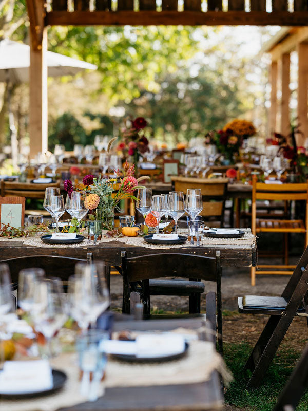 Outdoor dining with tables and flower arrangements