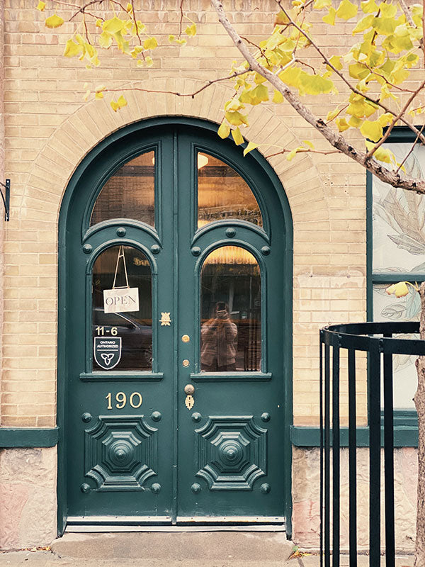 Green double door with decorative elements at Fridays Cannabis building