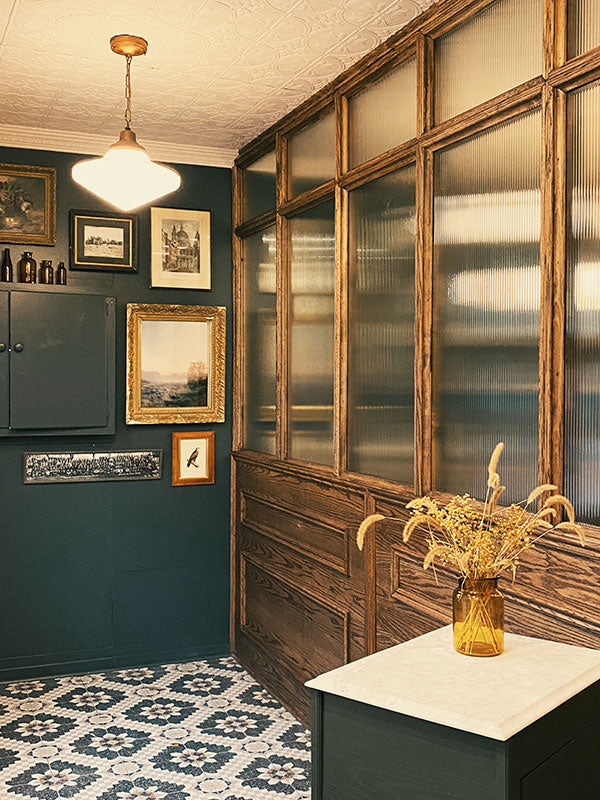Narrow hallway with privacy partition, framed pictures at Fridays Cannabis.