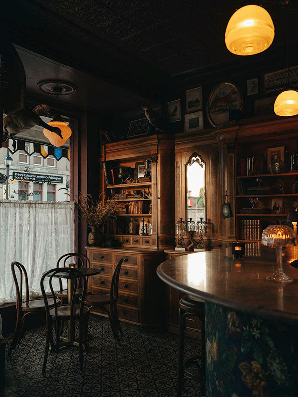 Dark interior of a bar with wooden furniture and vintage decor.