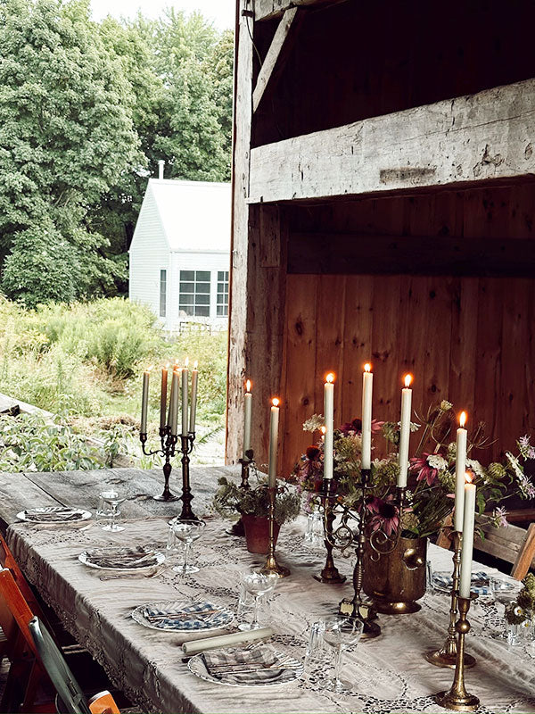 Dining table set outdoors with candles and rustic decor